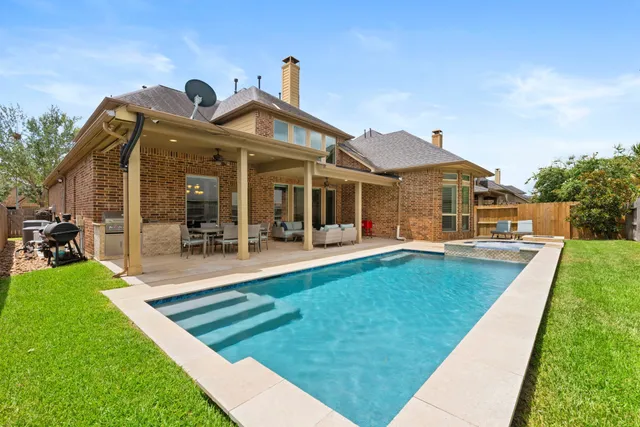 a view of a house with swimming pool and porch