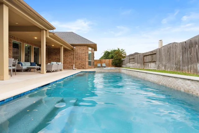 a view of an house with backyard and porch