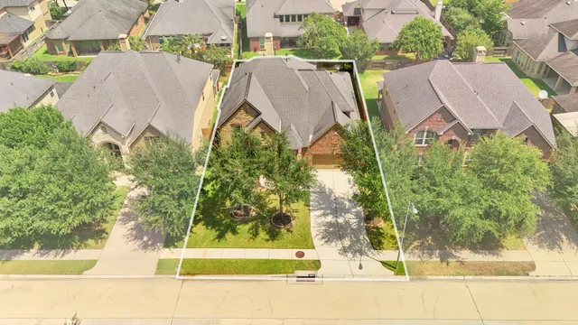 a view of a house with a yard and a street view