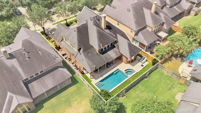 an aerial view of a house with a swimming pool