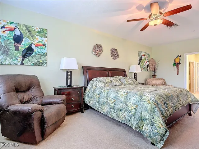 a bedroom with a bed and ceiling fan
