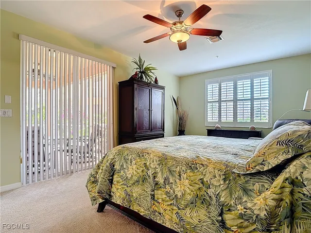 a bed sitting in a spacious bedroom next to a window
