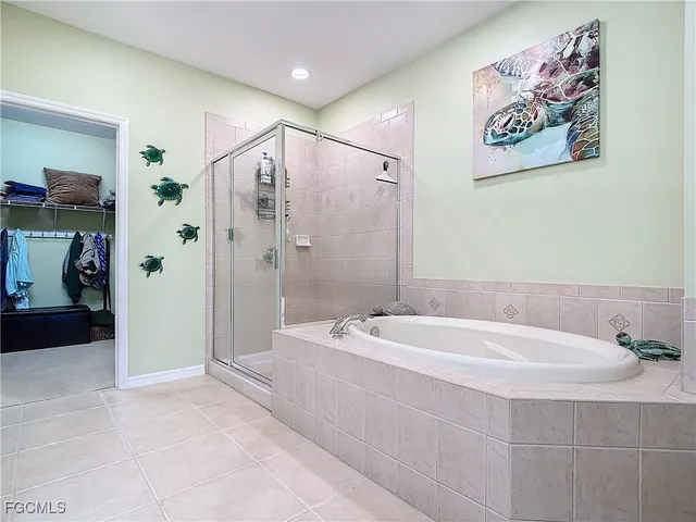 a bathroom with a tub a sink and glass door shower