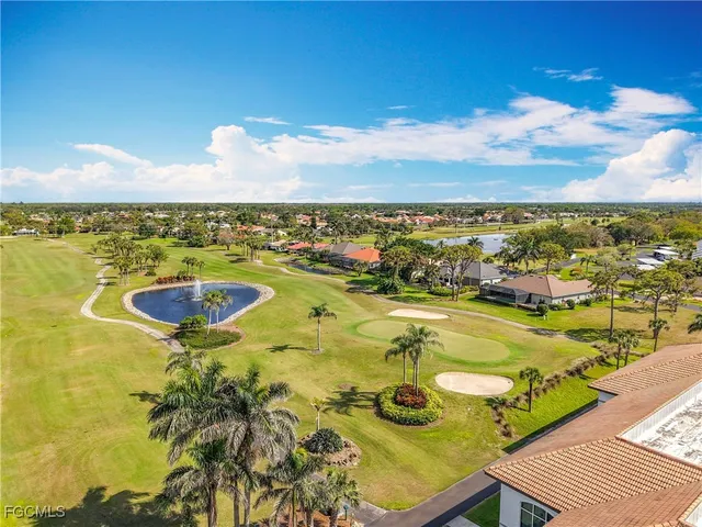 a front view of multi story residential apartment building with yard