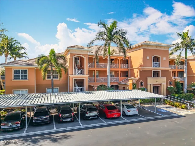 a view of a lake with a table and chairs under an umbrella