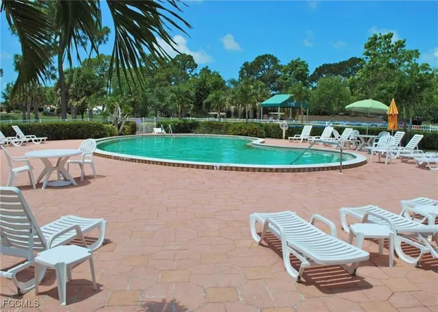 an aerial view of a house with a yard and large trees