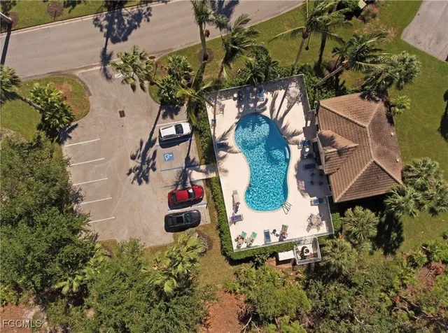 a view of house with swimming pool and outdoor seating