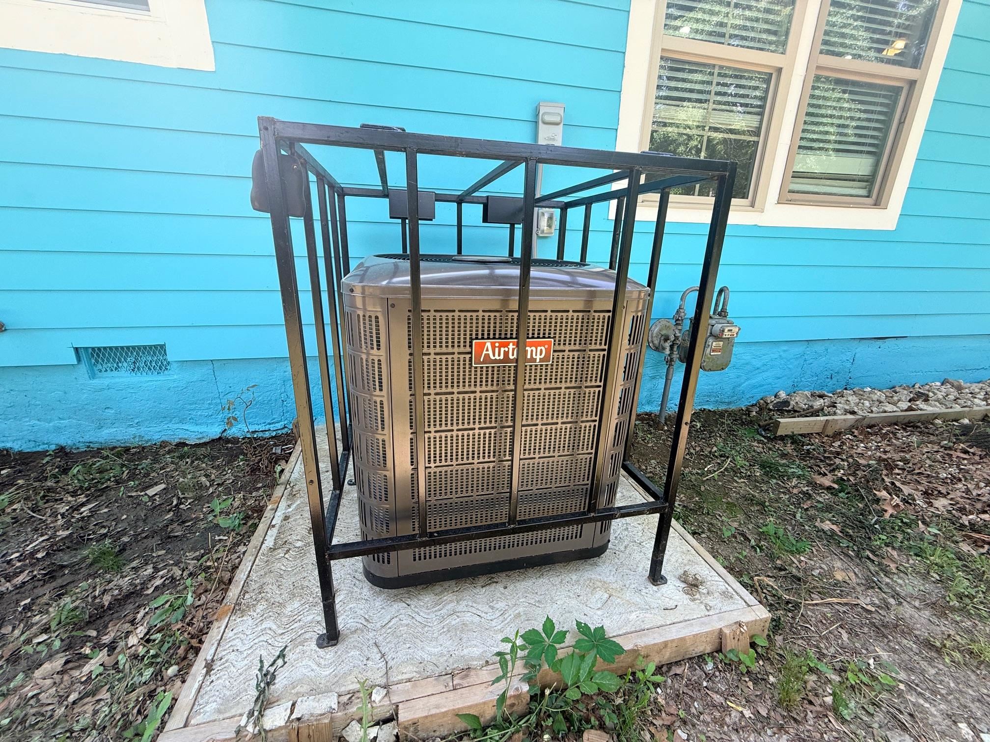 3054 Lotus Road Memphis, TN 38109 - Photo 26 of 29 Exterior utility area featuring a central air conditioning unit on a concrete pad, enclosed by a metal security cage