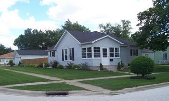 922 Ave A Rochelle, IL 61068 - Photo 1 of 1 a front view of a house with a garden and trees