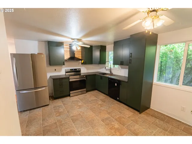 a kitchen with kitchen island a sink stainless steel appliances and cabinets