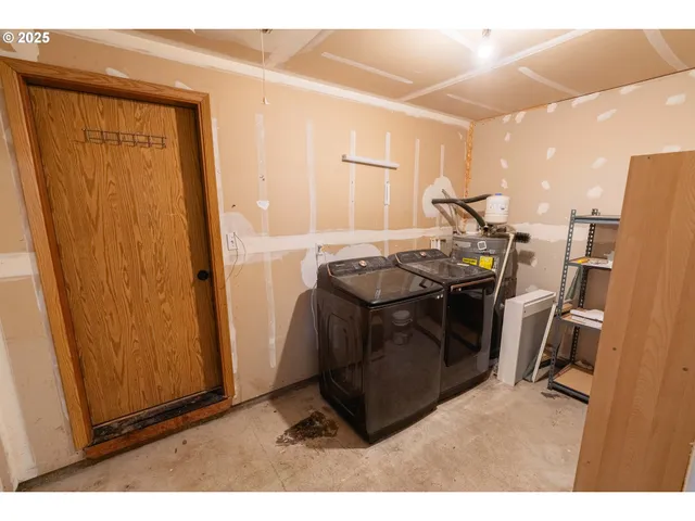 a utility room with sink dryer and washer