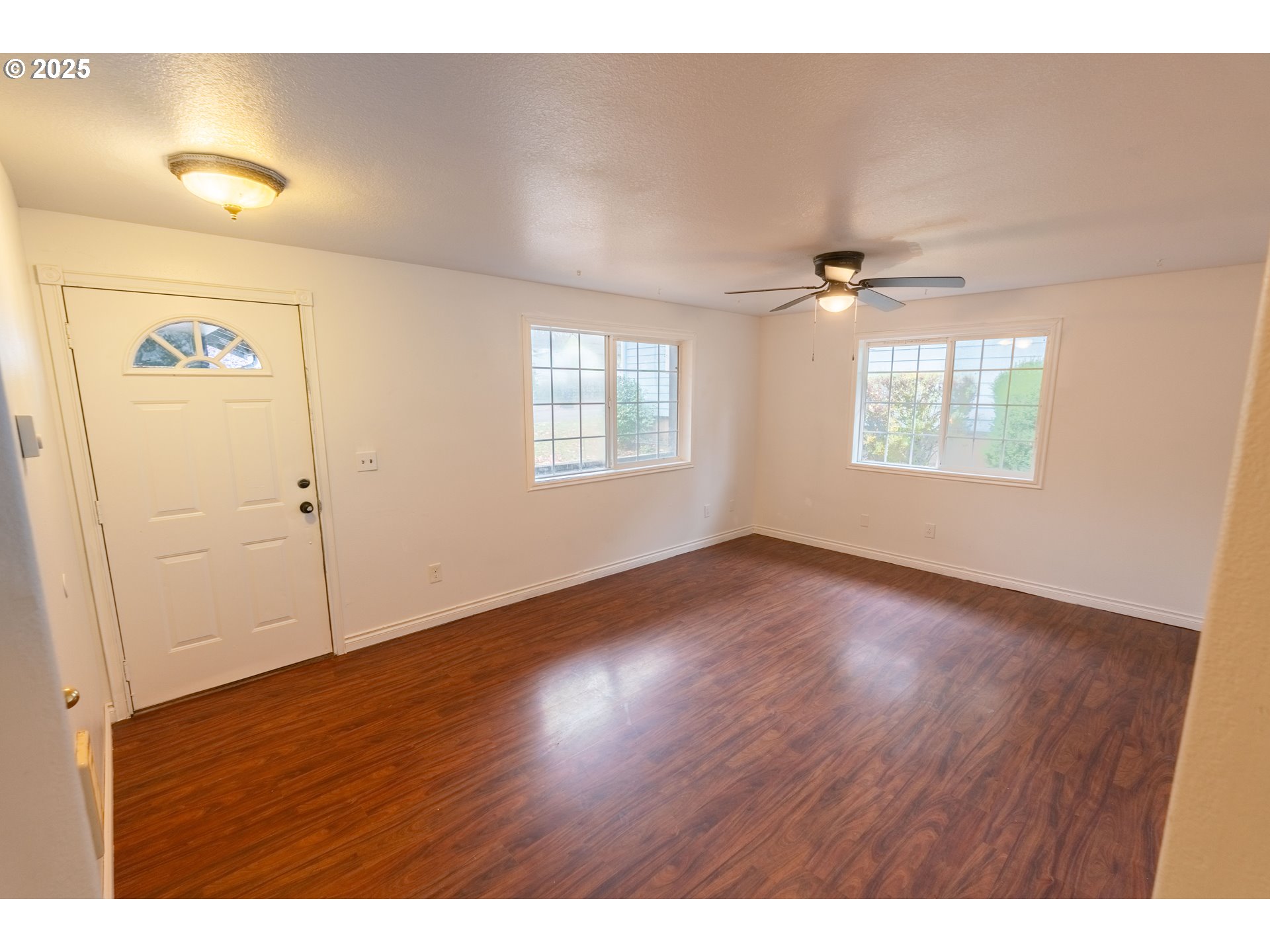 219 Northeast 18th Avenue Camas, WA 98607 - Photo 9 of 34 a view of an empty room with wooden floor and a window