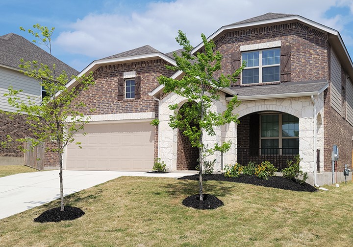 a front view of a house with a yard