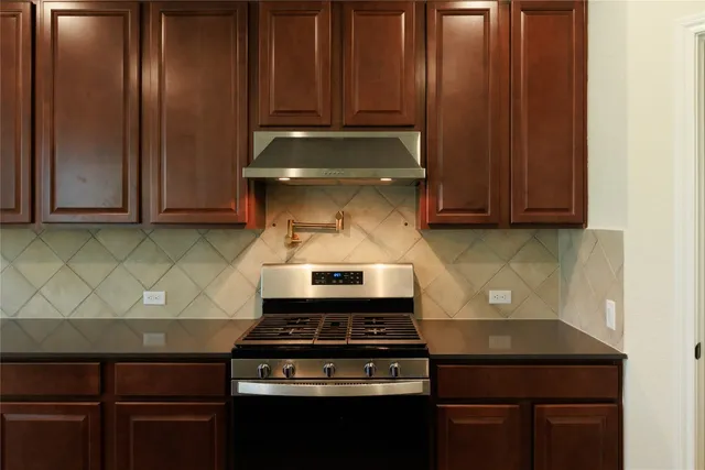 a stove top oven sitting inside of a kitchen