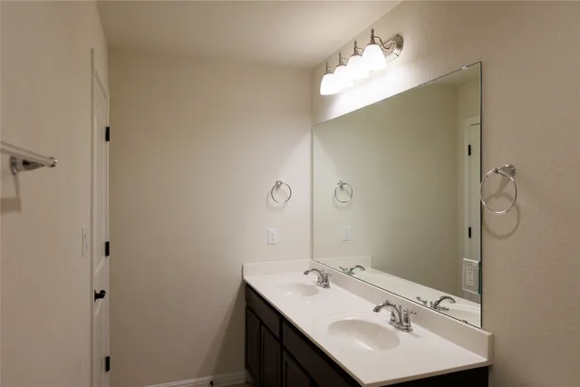 a bathroom with a sink and mirror