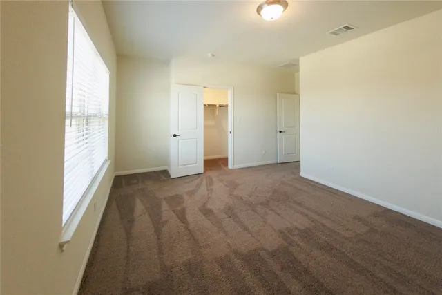 an empty room with windows and entrance