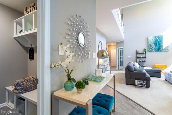 a living room with furniture and chandelier