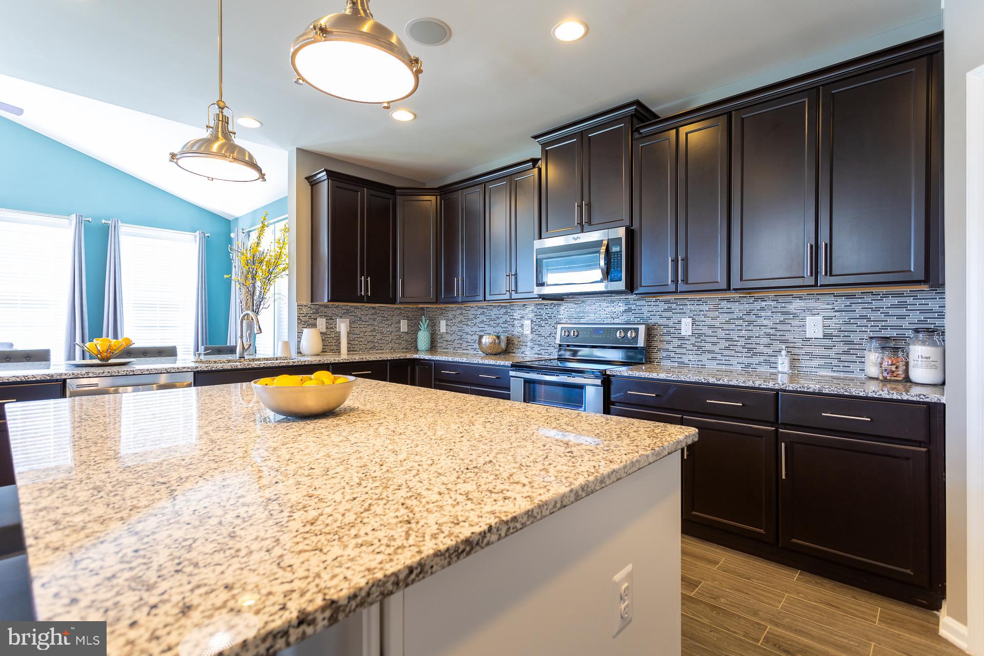 668 Marquee Farm Road Charles Town, WV 25414 - Photo 4 of 50 a kitchen with a stove a sink and a cabinets