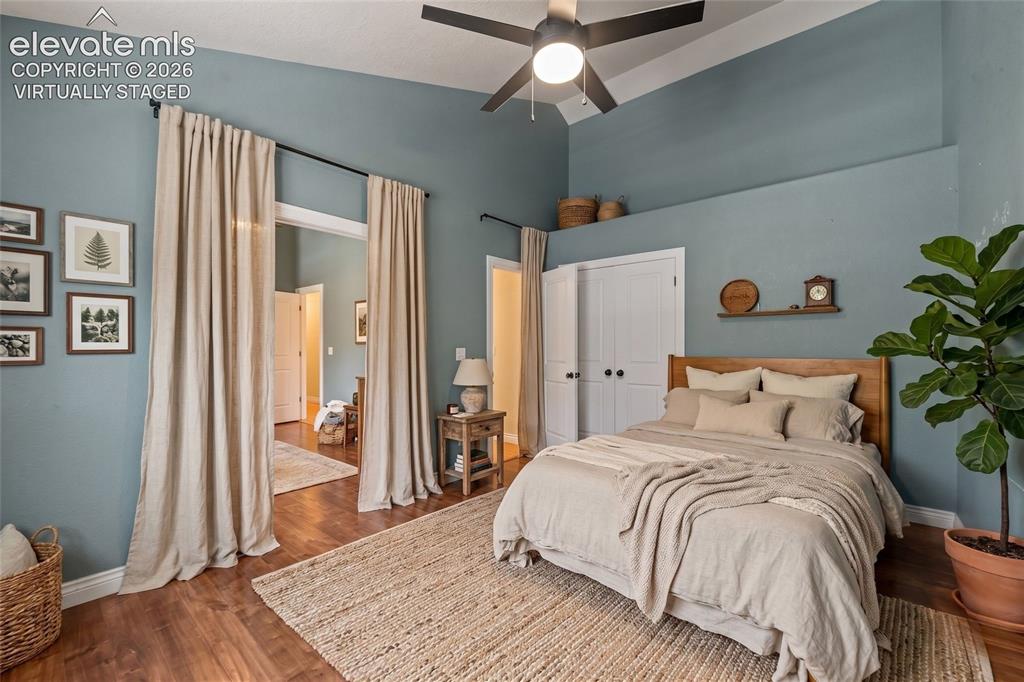 16540 Mesquite Road Peyton, CO 80831 - Photo 23 of 50 a bedroom with a large bed and a chandelier