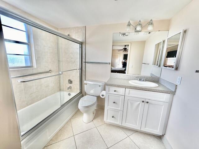 4001 Hythe A Boca Raton, FL 33434 - Photo 10 of 38 a bathroom with a granite countertop sink a mirror and a toilet