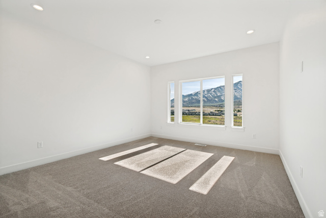 1351 Maple Circle Santaquin, UT 84655 - Photo 17 of 42 Expansive room featuring a large picture window with mountain scenery, recessed lighting, neutral carpet, white walls, and white trim