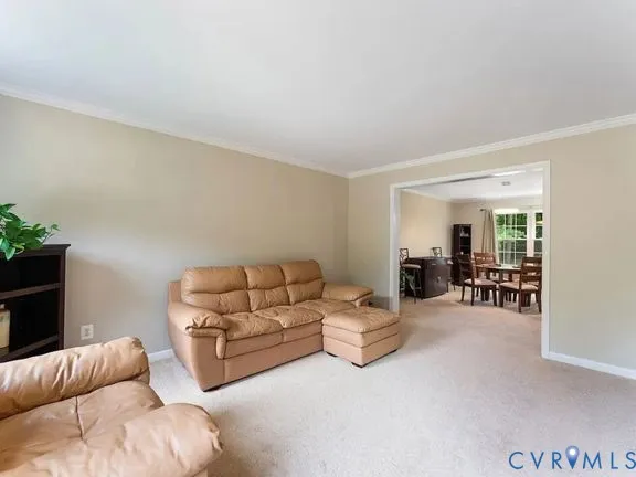 a living room with furniture and white walls