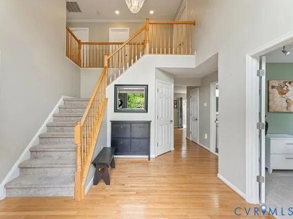 a view of entryway and hall with wooden floor