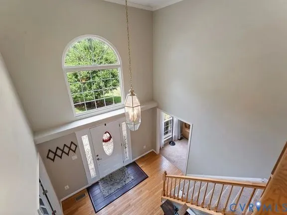 an empty room with wooden floor and a window