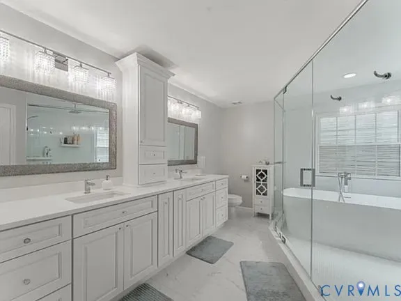 a spacious bathroom with a double vanity sink mirror and bathtub