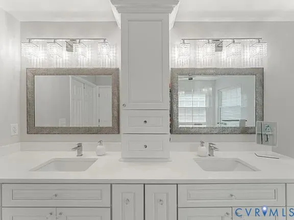 a bathroom with double sink and a mirror