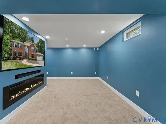 a view of an empty room with a fireplace and a floor to ceiling window