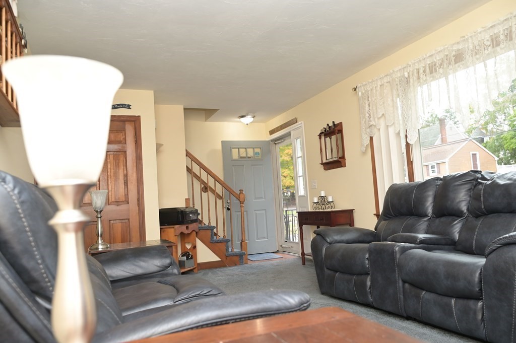 12 Martin Road, Unit 12 Douglas, MA 01516 - Photo 6 of 35 a living room with furniture a fireplace and a large window