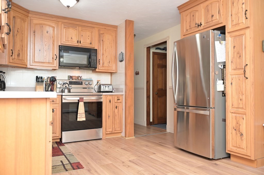 12 Martin Road, Unit 12 Douglas, MA 01516 - Photo 8 of 35 a kitchen with stainless steel appliances granite countertop a refrigerator stove and sink