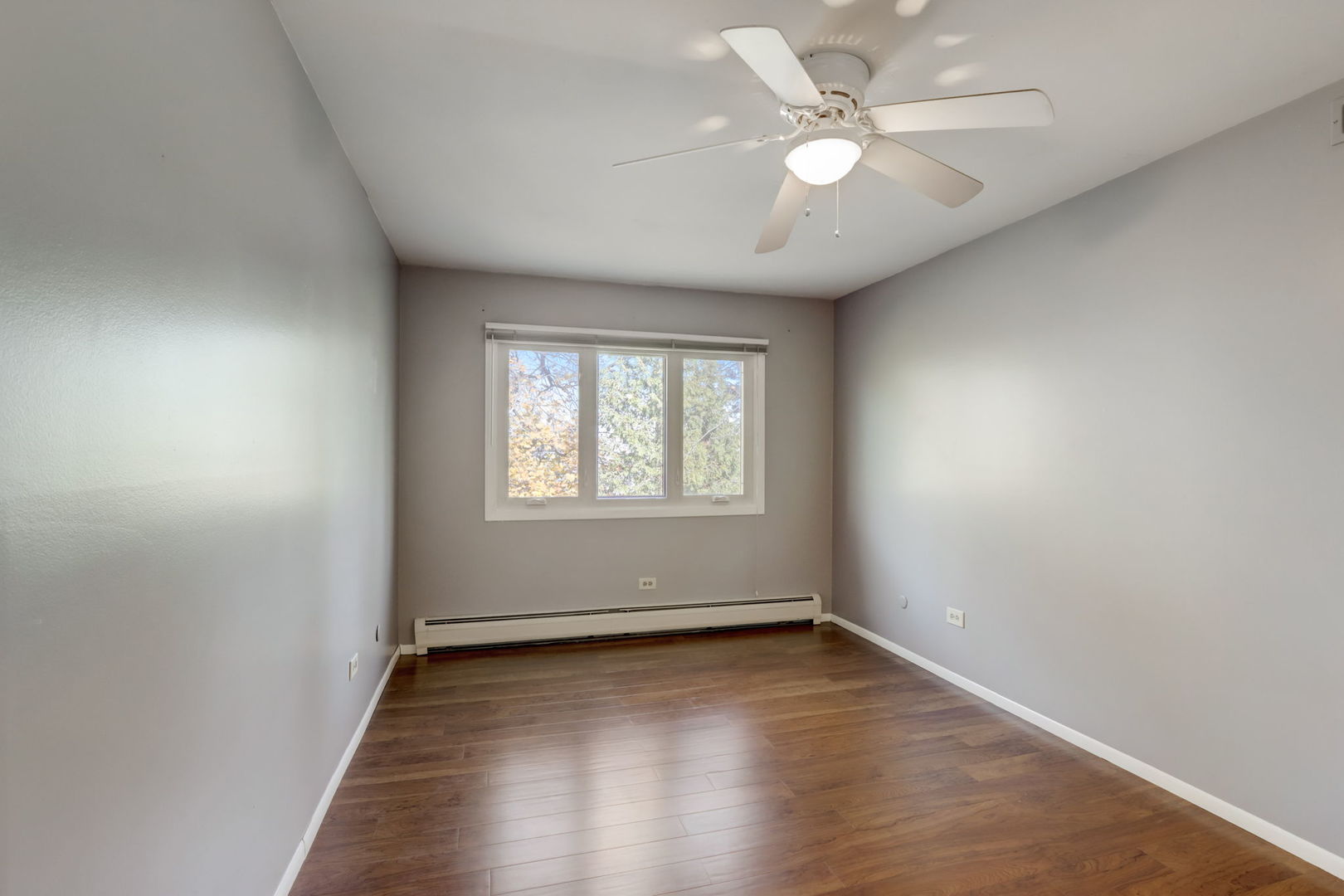 550 East Main Street, Unit 2E Barrington, IL 60010 - Photo 12 of 19 an empty room with wooden floor and windows