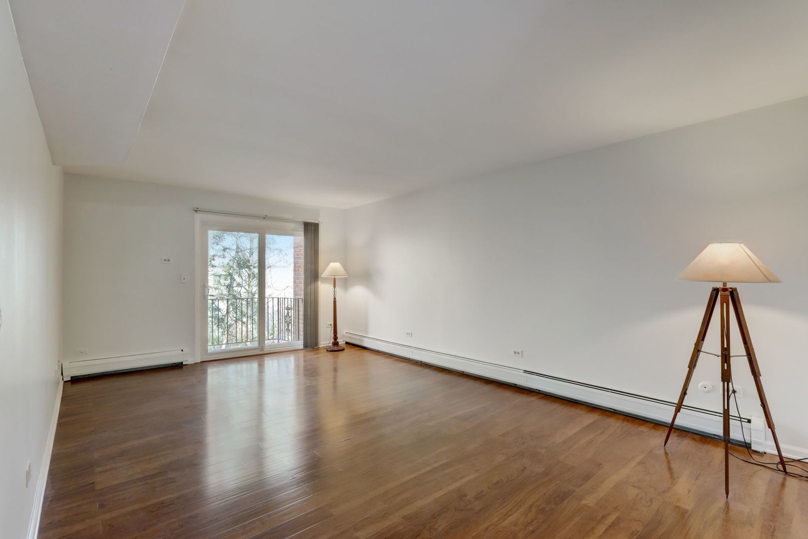 550 East Main Street, Unit 2E Barrington, IL 60010 - Photo 4 of 19 a view of an empty room and wooden floor and a window