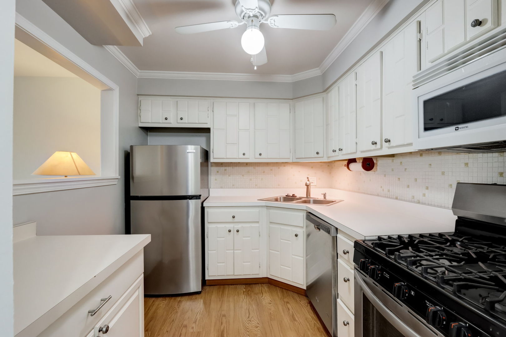550 East Main Street, Unit 2E Barrington, IL 60010 - Photo 6 of 19 a kitchen with a sink a stove and refrigerator