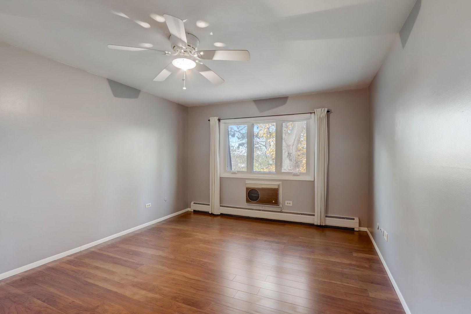 550 East Main Street, Unit 2E Barrington, IL 60010 - Photo 10 of 19 an empty room with wooden floor and windows