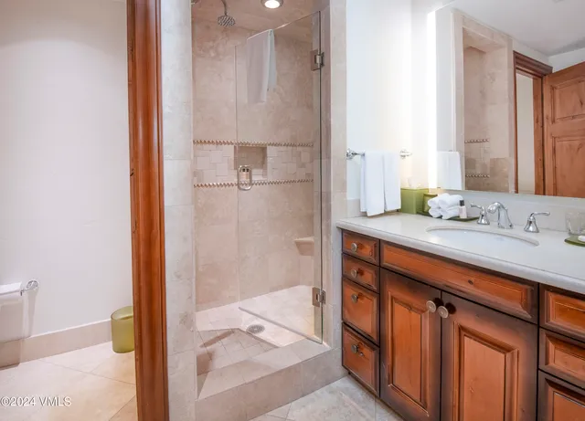a bathroom with a sink a mirror and a shower