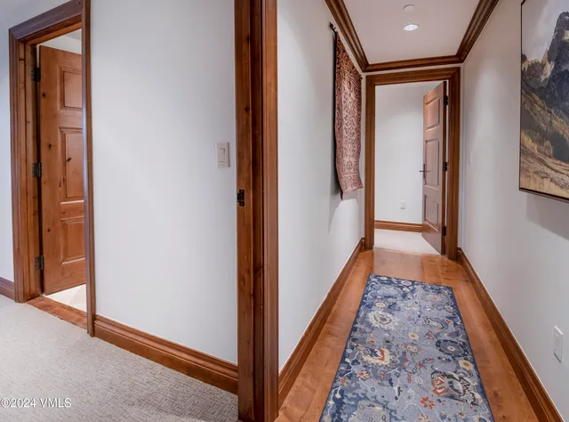a view of hallway with wooden floor