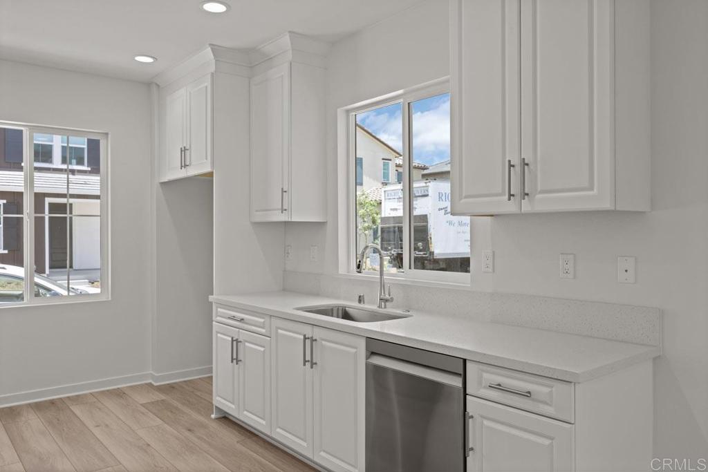 740 Kingbird Loop Oceanside, CA 92058 - Photo 20 of 23 a kitchen with stainless steel appliances white cabinets and a sink