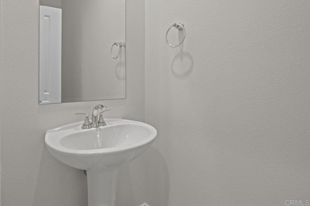 740 Kingbird Loop Oceanside, CA 92058 - Photo 21 of 23 a bathroom with a sink and a mirror