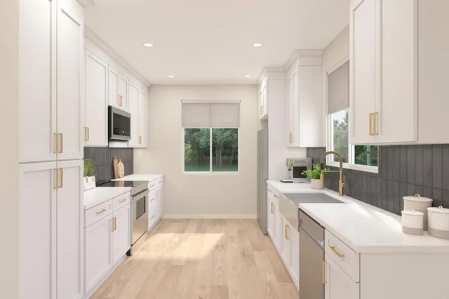a large white kitchen with a window