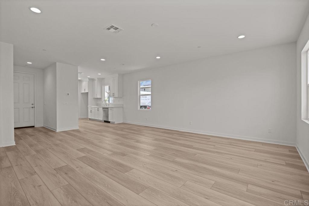 740 Kingbird Loop Oceanside, CA 92058 - Photo 6 of 23 a view of empty room with wooden floor and fan