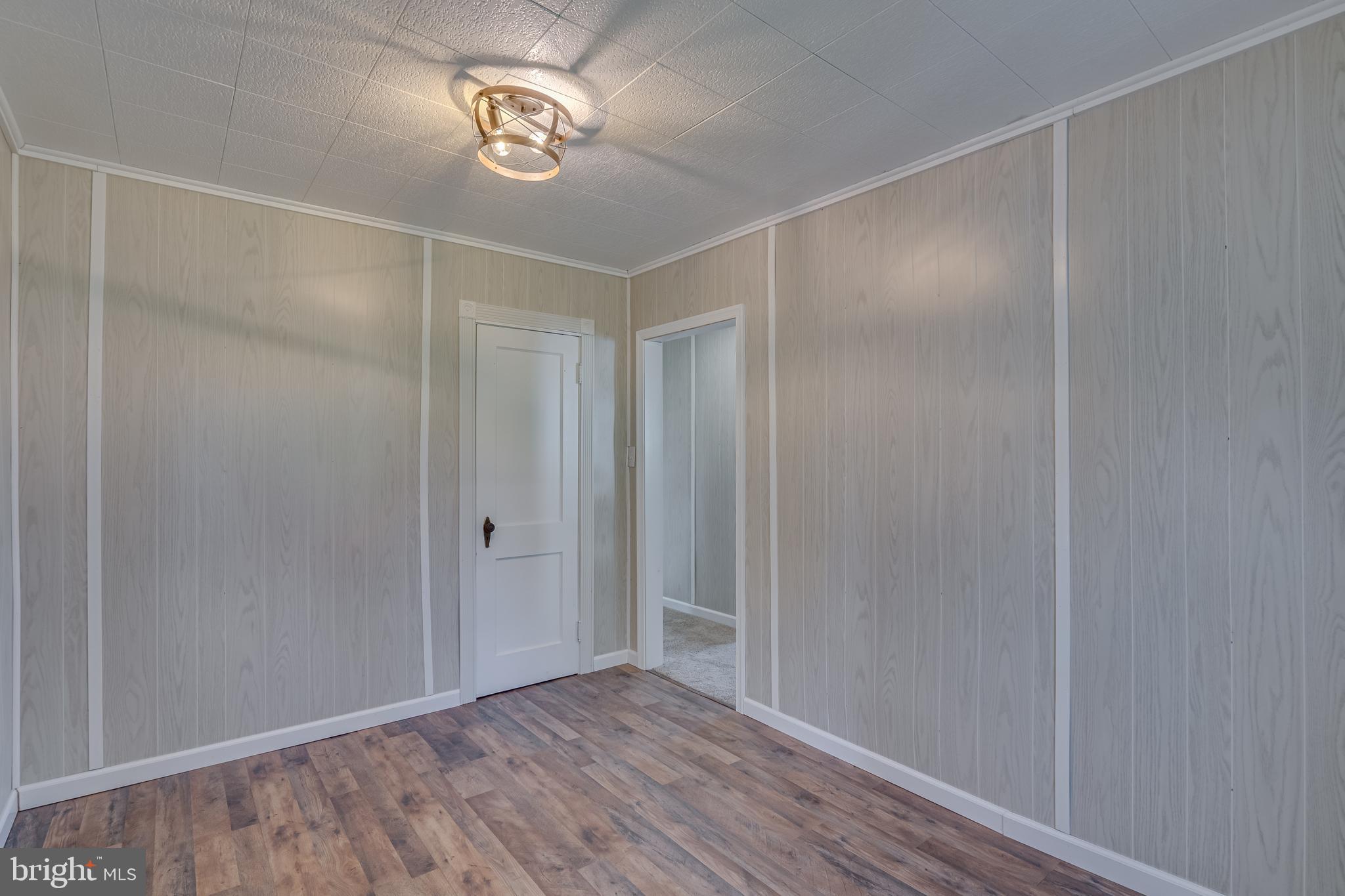 56 Clems Drive Ranson, WV 25438 - Photo 11 of 25 a view of an empty room with wooden floor