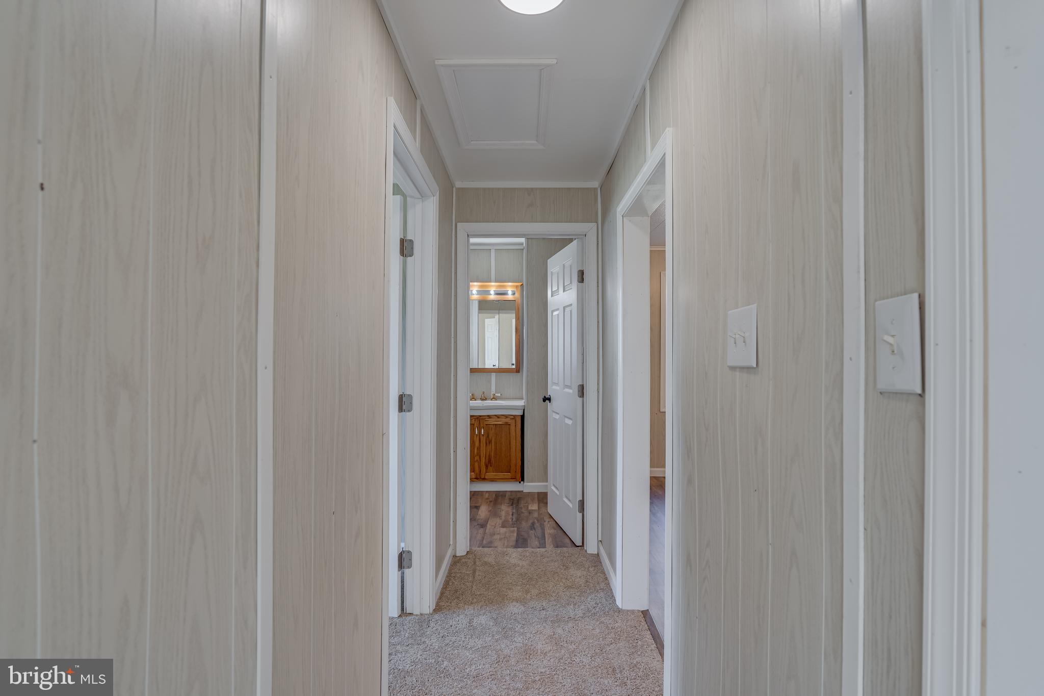56 Clems Drive Ranson, WV 25438 - Photo 16 of 25 a view of a hallway with wooden shelves