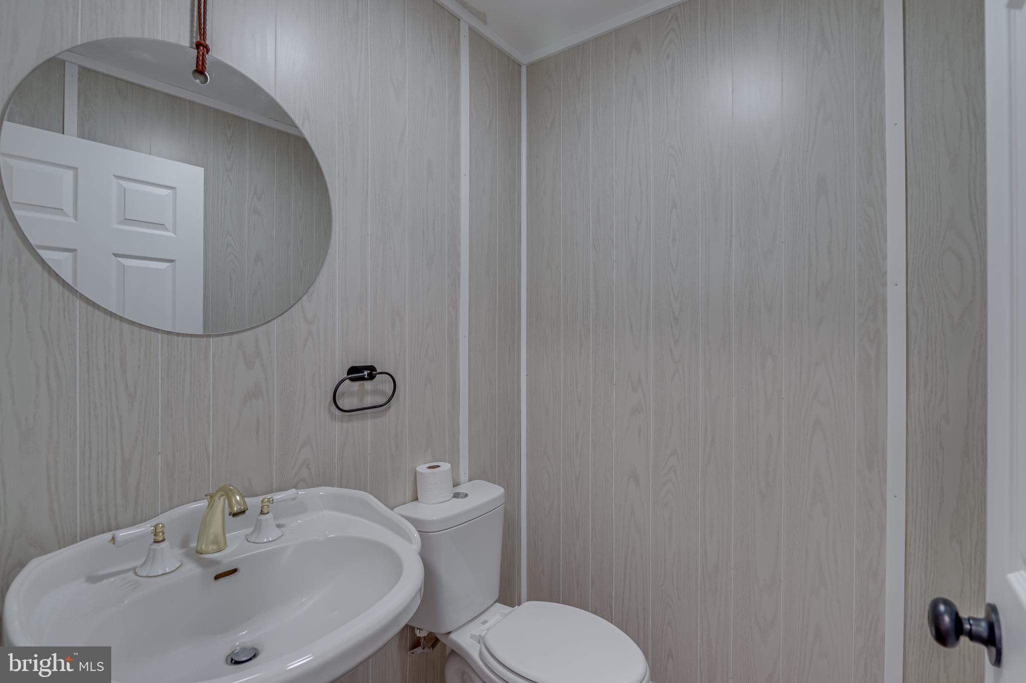 56 Clems Drive Ranson, WV 25438 - Photo 22 of 25 a bathroom with a sink and mirror