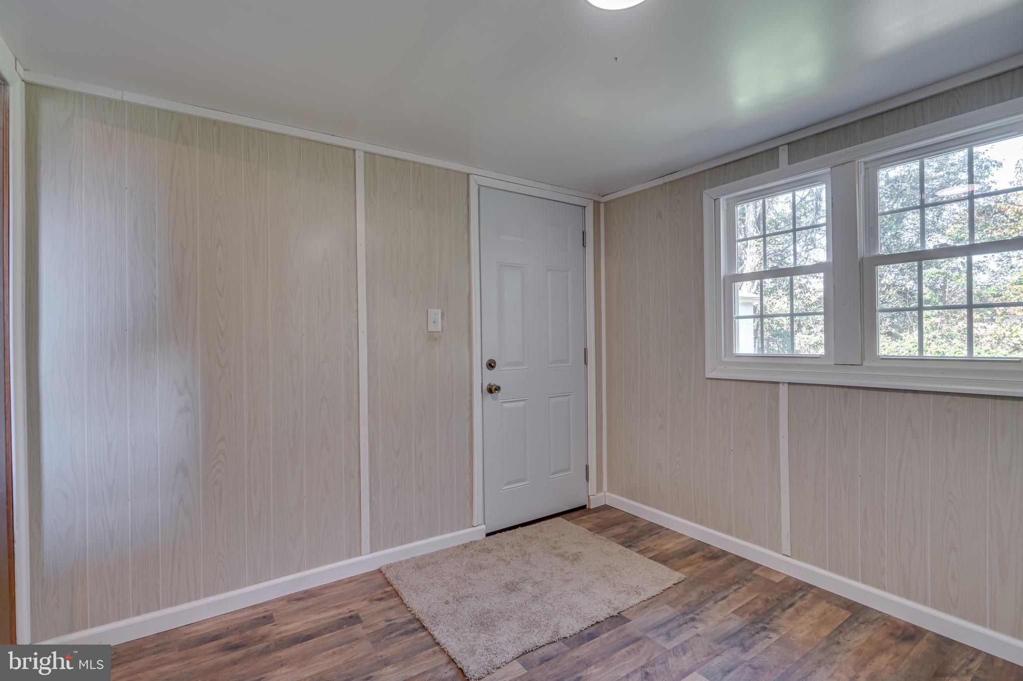 56 Clems Drive Ranson, WV 25438 - Photo 24 of 25 a view of an empty room with wooden floor and a window