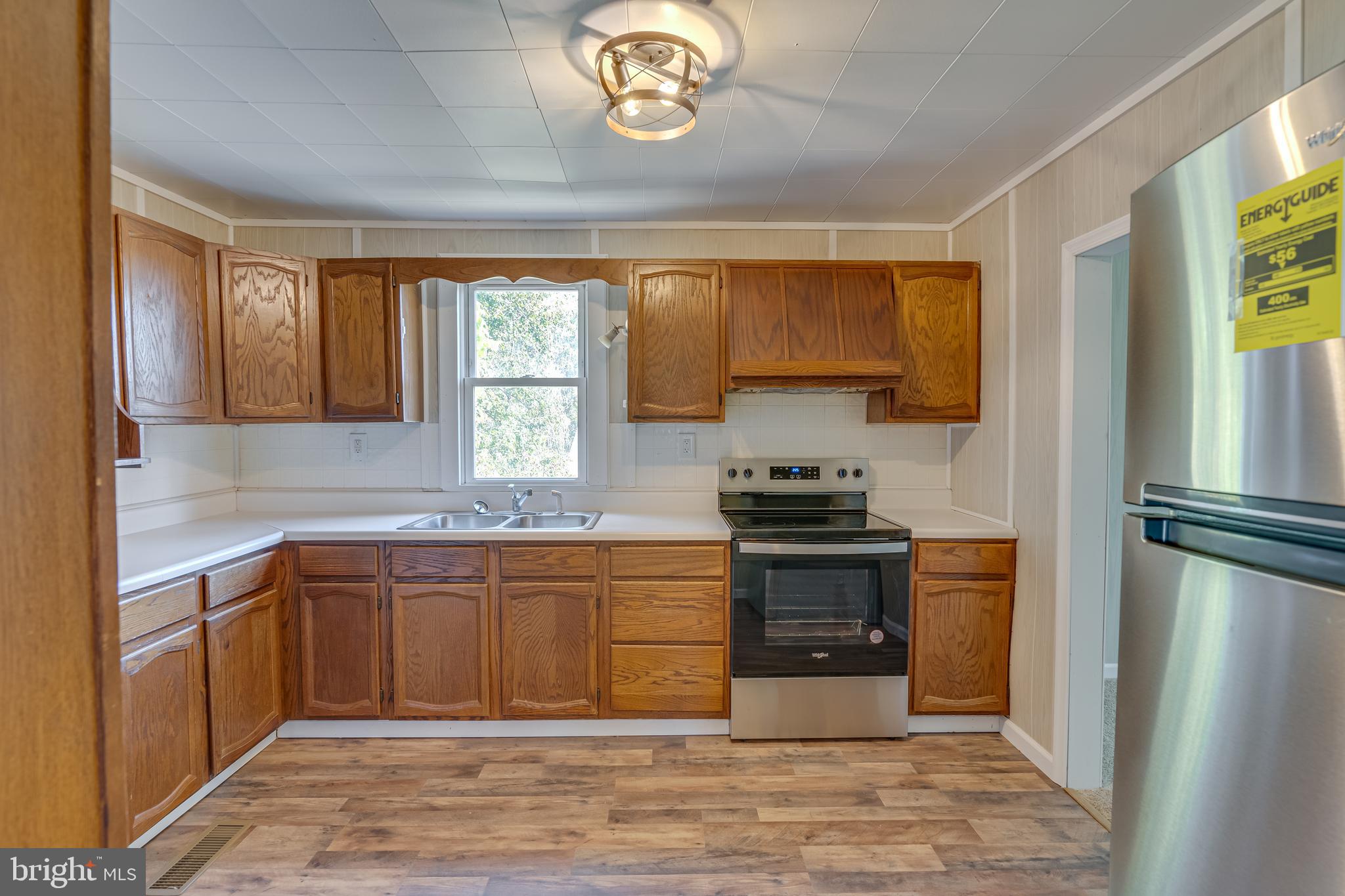 56 Clems Drive Ranson, WV 25438 - Photo 3 of 25 a kitchen with stainless steel appliances granite countertop a stove a sink and a refrigerator