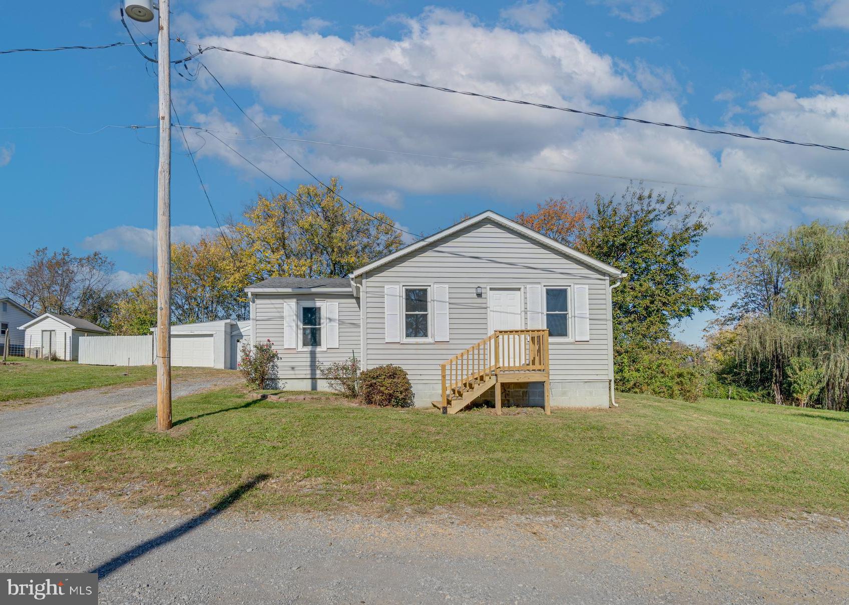 56 Clems Drive Ranson, WV 25438 - Photo 8 of 25 a view of a house with a yard and large tree