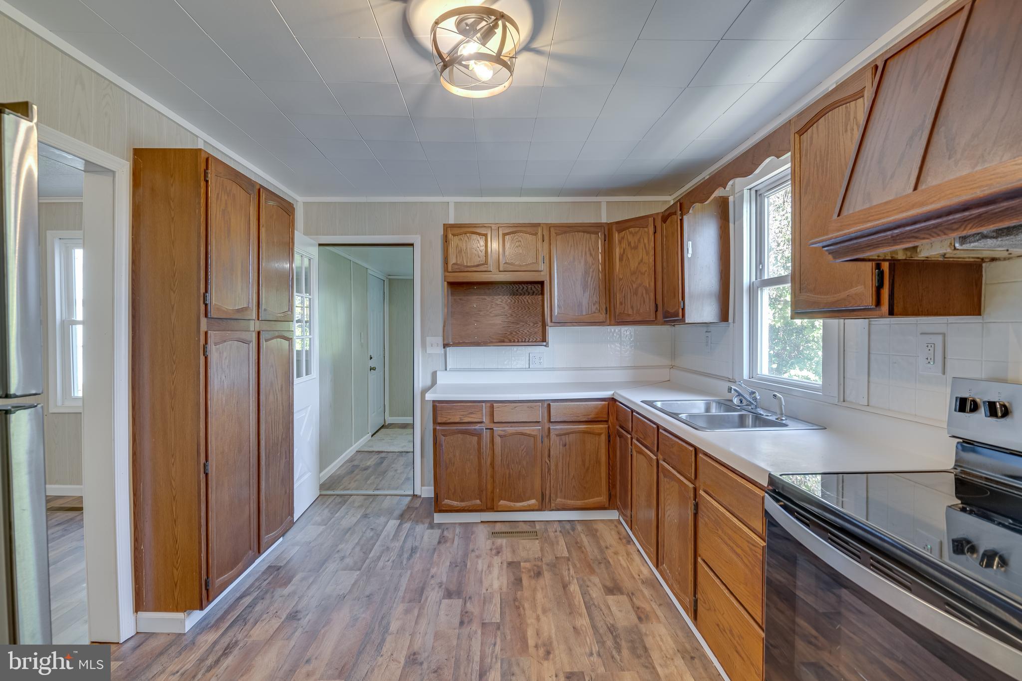 56 Clems Drive Ranson, WV 25438 - Photo 10 of 25 a kitchen with a sink stove and cabinets